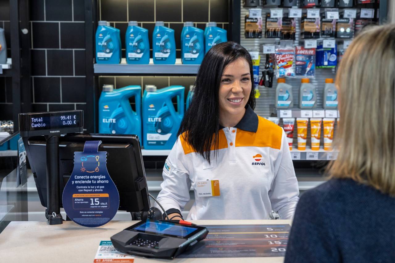 Repsol service station worker with a customer