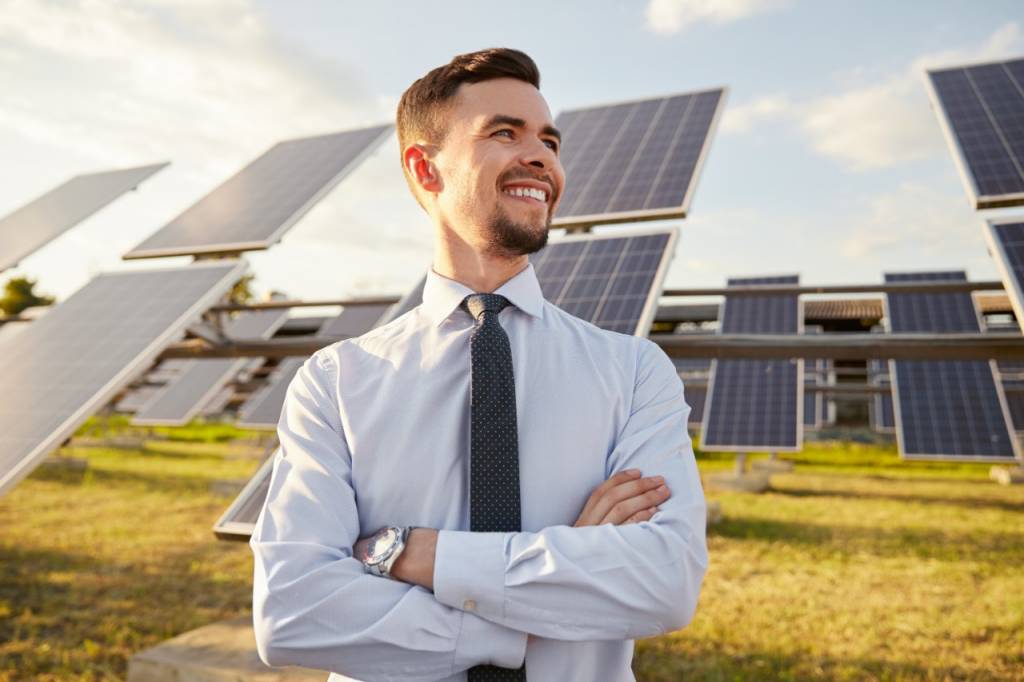 An investor surrounded by solar panels