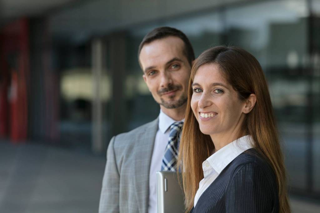 Two Repsol employees pose smiling
