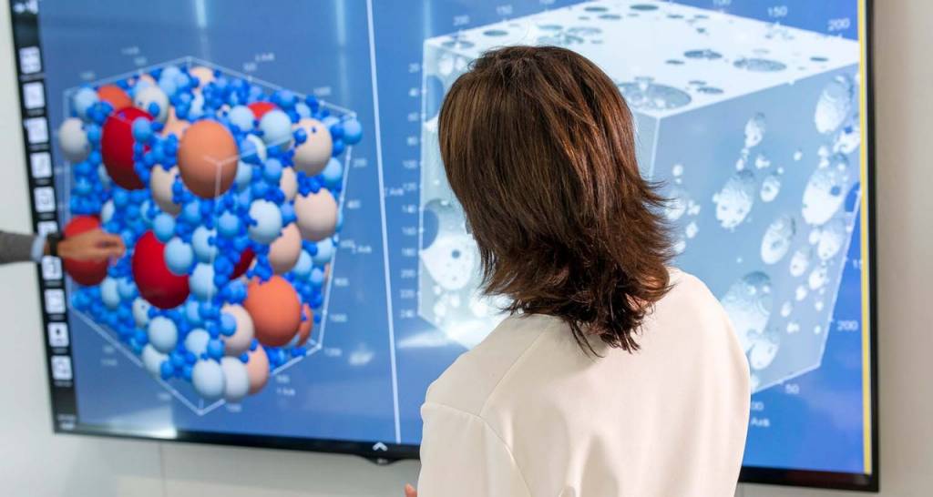 A scientist observing data on a screen
