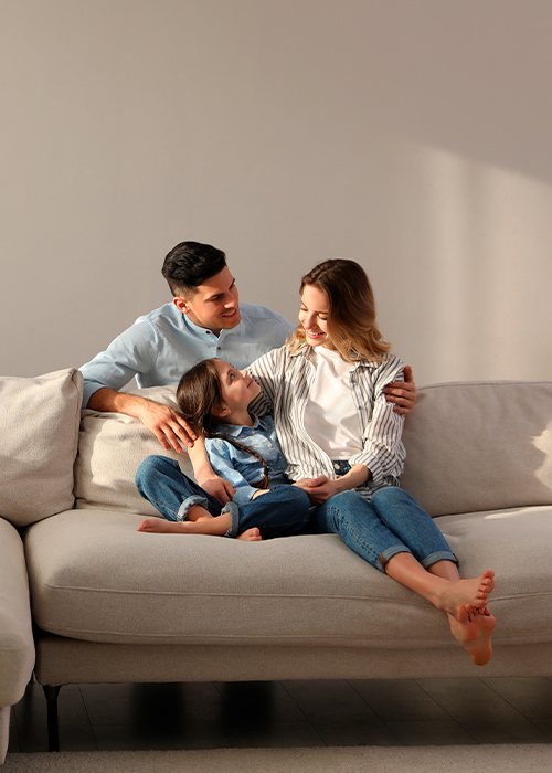 A family sitting on a sofa