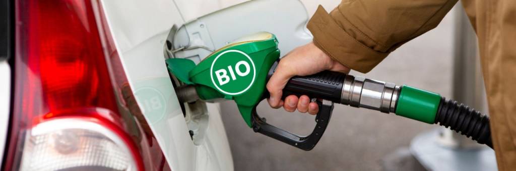 Person refueling car with biodiesel
