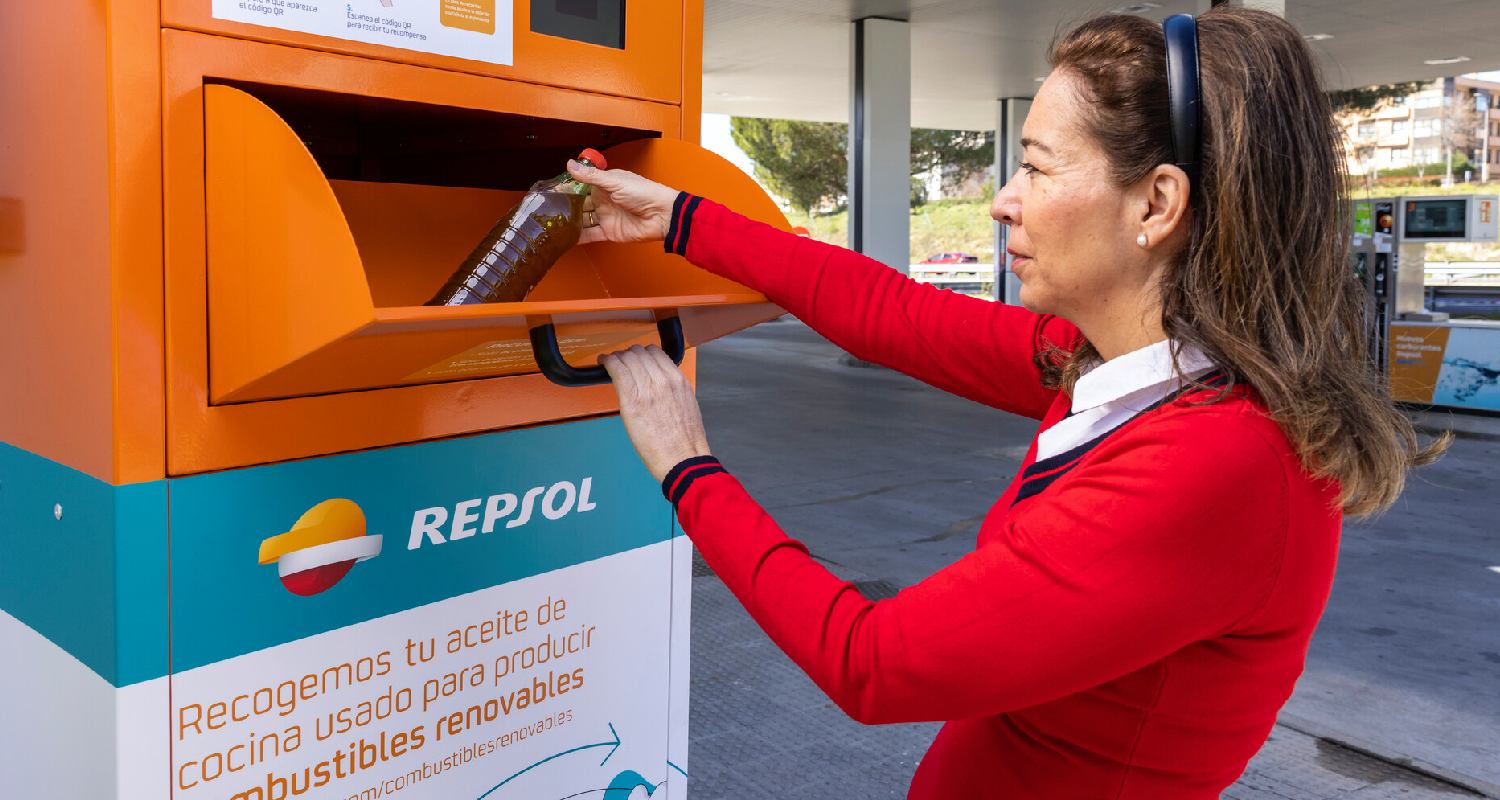 A woman recycling a bottle of used cooking oil