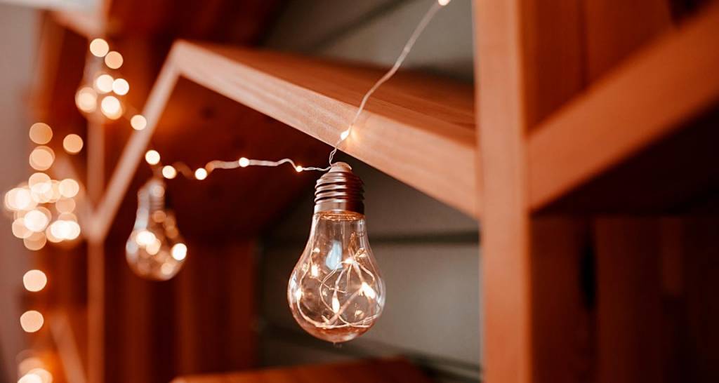 Light bulbs hanging from shelves
