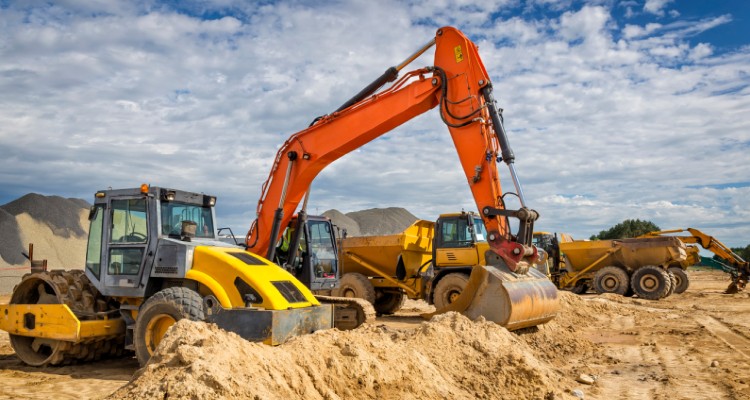 An excavator and other heavy machinery moving dirt