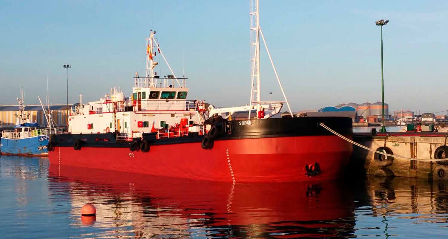 A red vessel at a port