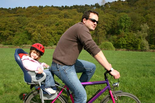 a father and his daughter on a bike, one of the most sustainable forms of transport