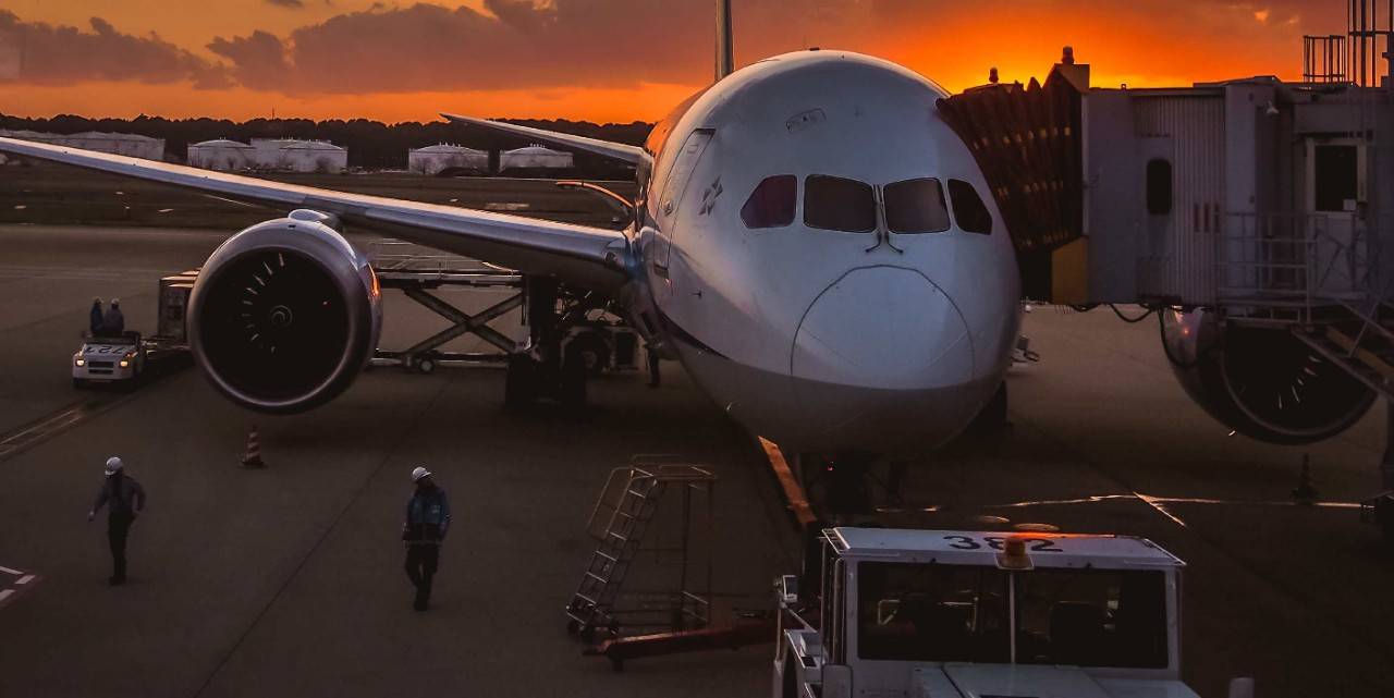 View of an airplane in an airport at dusk